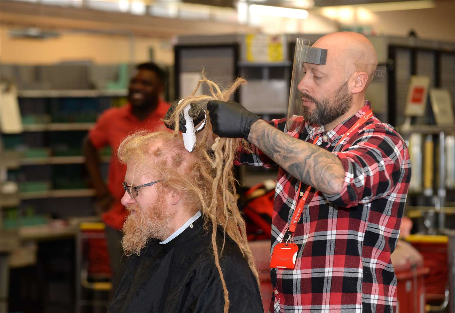 Royal mail Delivery Office, Bishop's Stortford.Postie Jeremy White having his dreadlocks cut off and his head shaved for charity.Fellow postie and barber Dan Whitbread did the honours. .Pic Vikki Lince. (42764770)