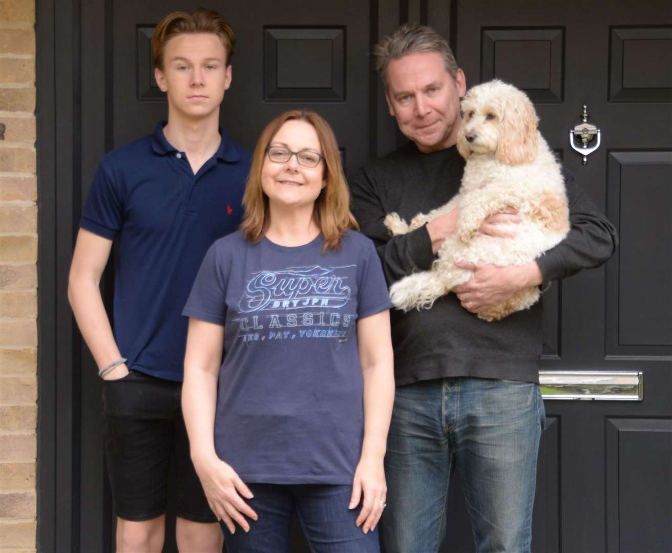 Cate Wilson with husband Scott, son Jacob and Lily Pickle the dog. Picture: Vikki Lince
