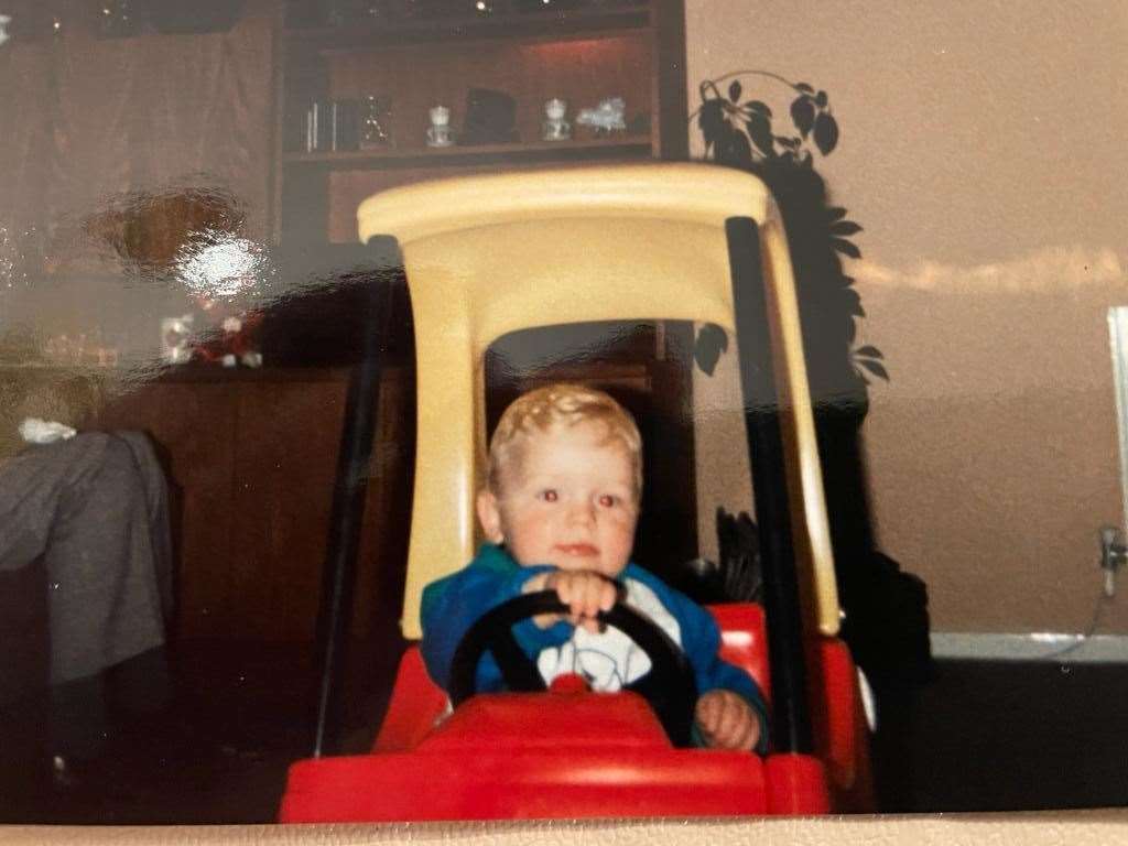 Tom in his Little Tykes red and yellow toy car, pretending to be Finnish Formula One world champion Mika Hakkinen