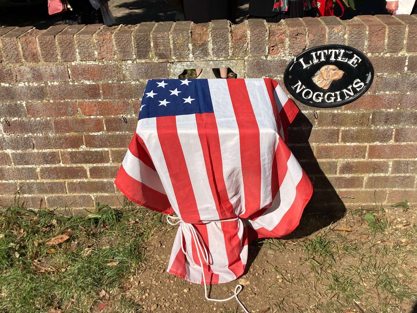 The memorial in Chelmsford Road draped in the Stars and Stripes before the unveiling
