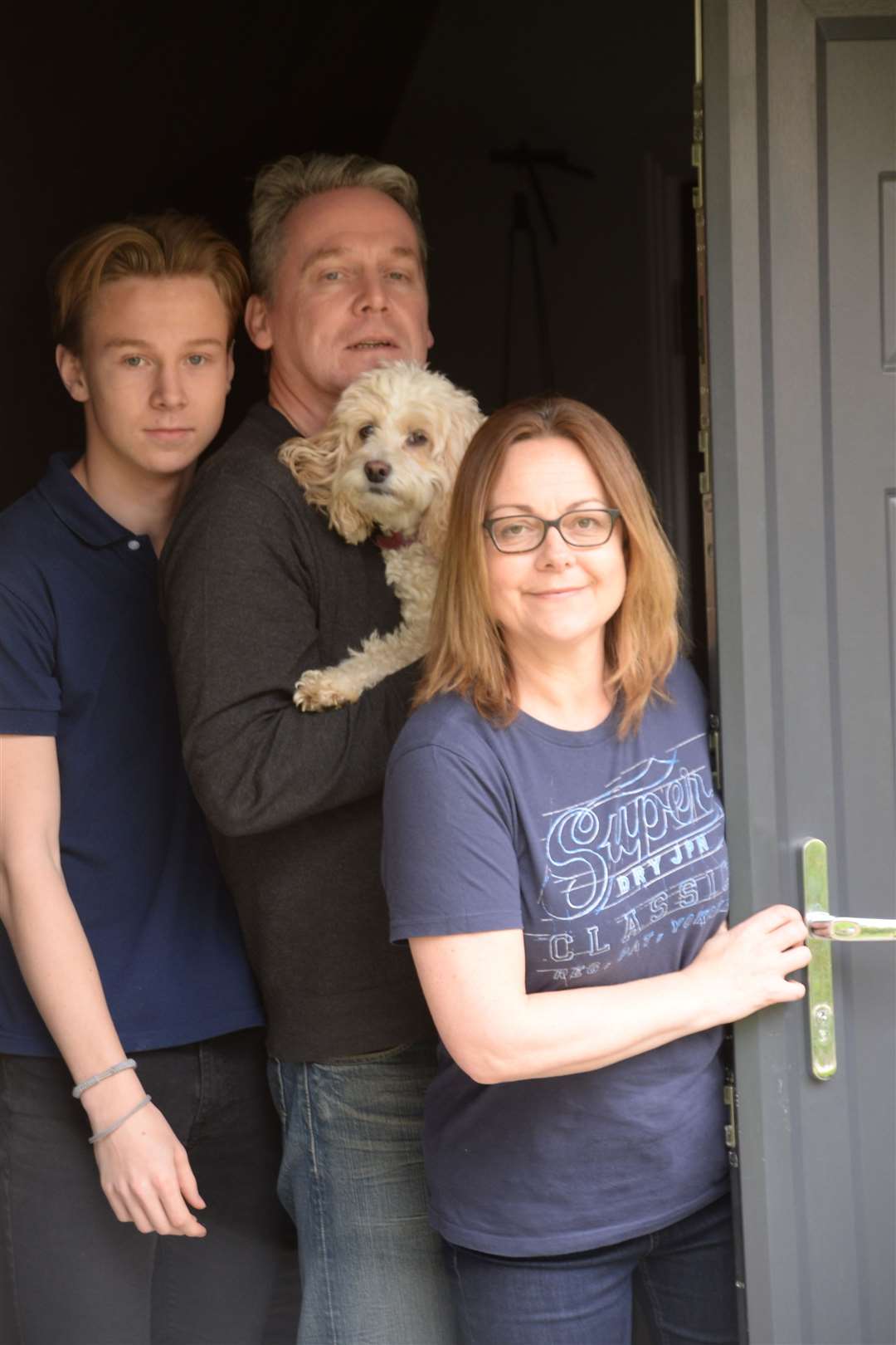 The Wilson family coping with lockdown – Cate with husband Scott, son Jacob and Lily Pickle the dog. Picture: Vikki Lince (33947596)